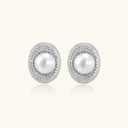Elegant stud earrings with cream freshwater pearls surrounded by sparkly pavé crystals on rhodium-plated silver setting