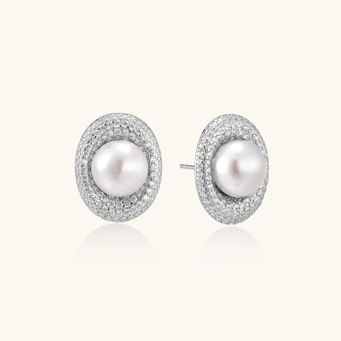 Elegant stud earrings with cream freshwater pearls surrounded by sparkly pavé crystals on rhodium-plated silver setting