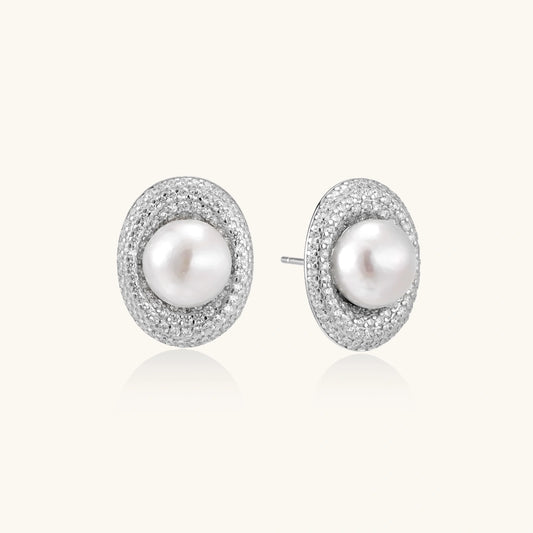 Elegant stud earrings with cream freshwater pearls surrounded by sparkly pavé crystals on rhodium-plated silver setting