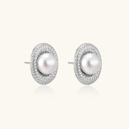 Elegant stud earrings with cream freshwater pearls surrounded by sparkly pavé crystals on rhodium-plated silver setting