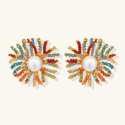 Vibrant starburst stud earrings with multicolor enamel rays and white pearl centers on gold-plated setting